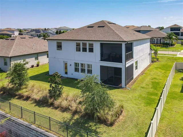 a view of a swimming pool with a table and chairs under an umbrella