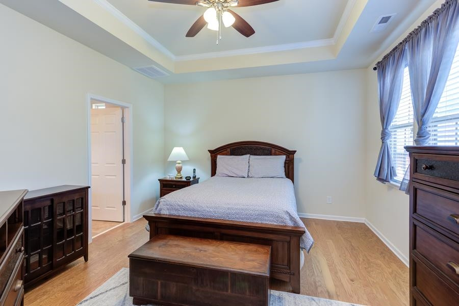 8612 Lasilla Way Raleigh, NC 27616 - Photo 13 of 27 Trey ceiling, windows that offer views to the back garden, a ceiling fan, and hardwood floors help make this a relaxing retreat at day's end. Master Bedroom