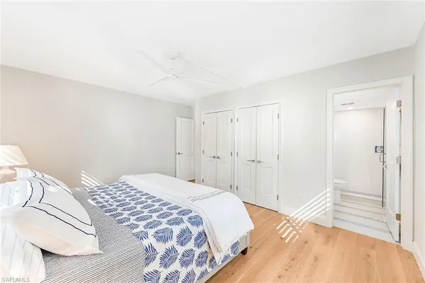 a bedroom with a bed and a mirror