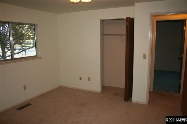 698 Empire Road Dayton, NV 89403 - Photo 7 of 12 an empty room with windows and closet