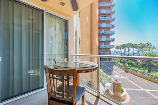 a balcony with table and chairs