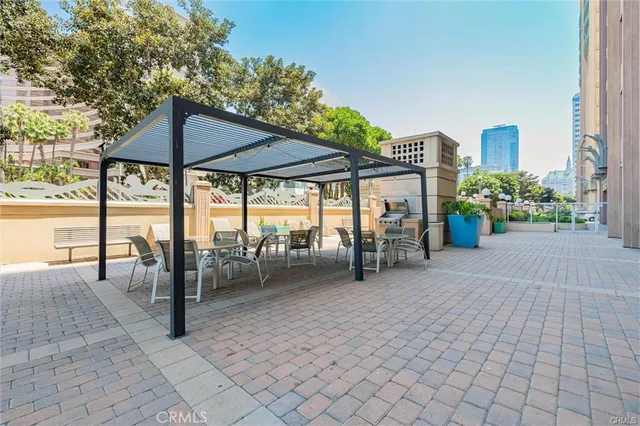 a view of a patio with a table and chairs under an umbrella
