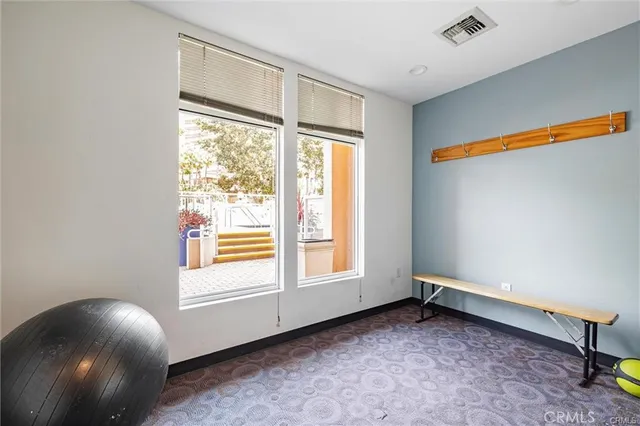 a view of a big room with wooden floor and windows