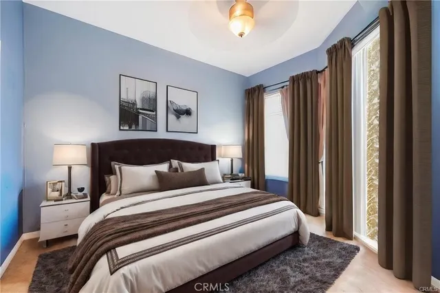 a bedroom with a large bed and a chandelier