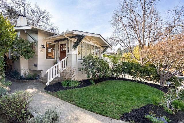 a front view of a house with a yard and pathway