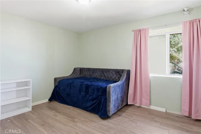 a living room with a couch and wooden floor