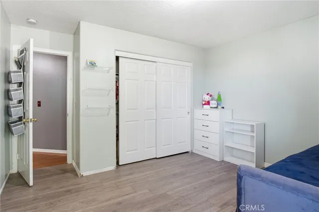 a bedroom with a bed and a book shelf