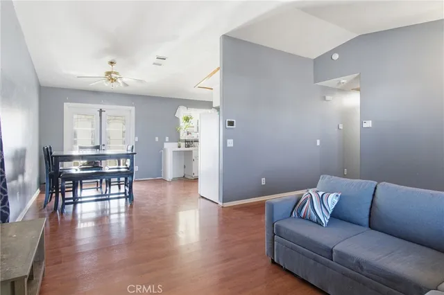 a living room with furniture and wooden floor