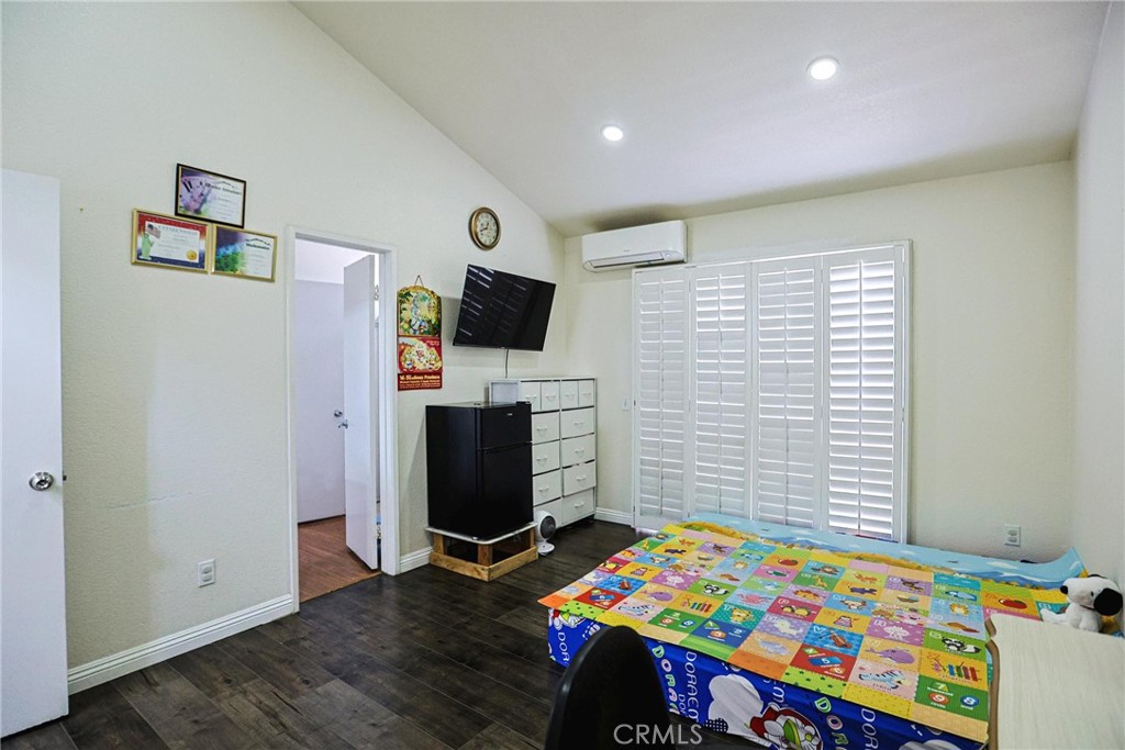 7912 2nd Street, Unit 4 Stanton, CA 90680 - Photo 11 of 16 a bedroom with a bed and a flat screen tv