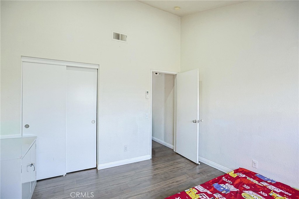 7912 2nd Street, Unit 4 Stanton, CA 90680 - Photo 13 of 16 an empty room with wooden floor and closet