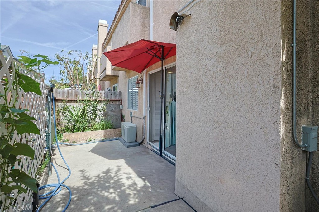 7912 2nd Street, Unit 4 Stanton, CA 90680 - Photo 14 of 16 a patio with glass top table and chairs