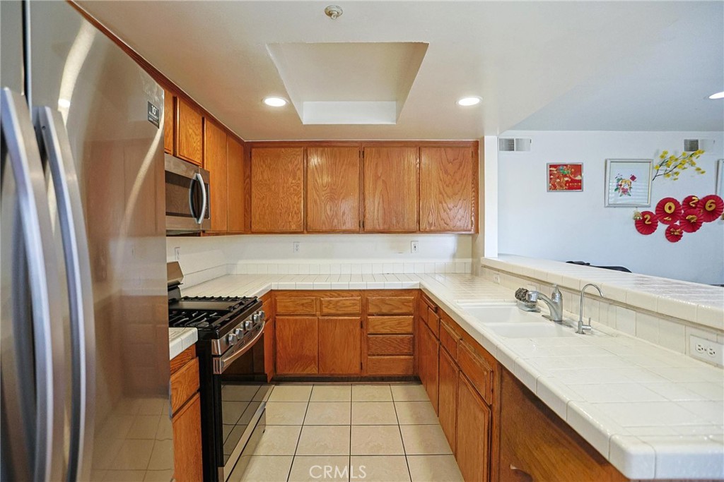 7912 2nd Street, Unit 4 Stanton, CA 90680 - Photo 4 of 16 a kitchen with stainless steel appliances granite countertop a sink stove and cabinets