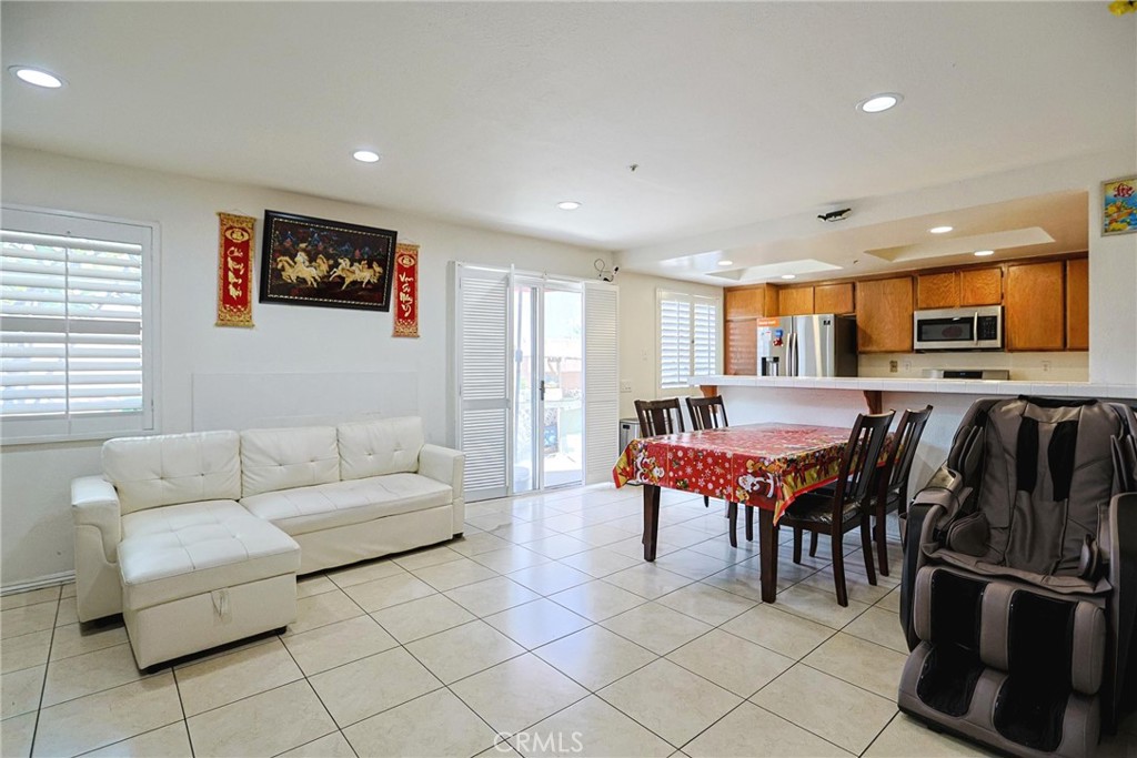 7912 2nd Street, Unit 4 Stanton, CA 90680 - Photo 5 of 16 a living room with furniture a flat screen tv and kitchen view