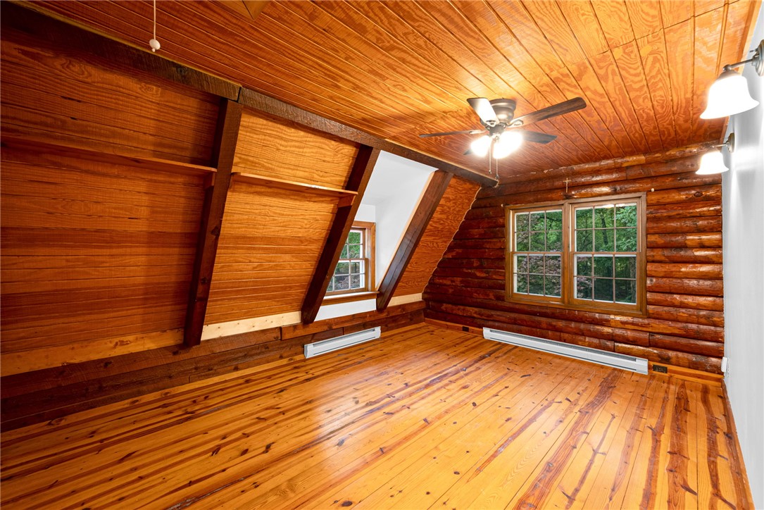 237 Spring Valley Road Liberty, SC 29657 - Photo 14 of 50 Natural wood tones envelop this charming attic space, offering a peaceful retreat with abundant light.