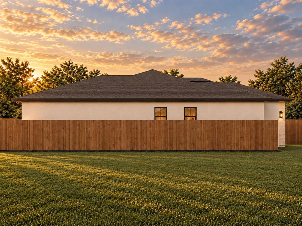 5738 Plum Dale Road Dallas, TX 75241 - Photo 2 of 4 Expansive backyard with manicured lawn, full-height wooden privacy fencing, and a stucco exterior