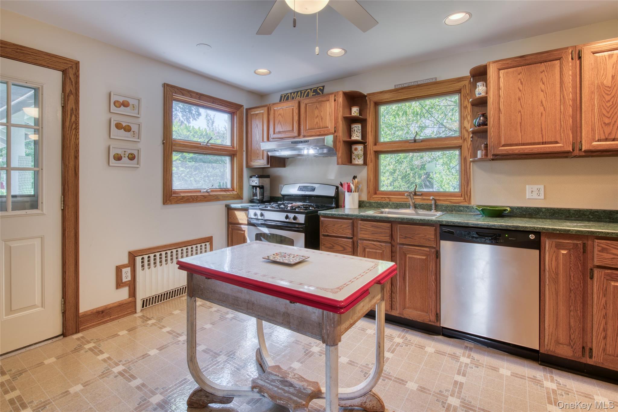 385 Cottage Place Southold, NY 11971 - Photo 6 of 14 a kitchen with stainless steel appliances granite countertop a stove a sink dishwasher a microwave oven with granite countertops and cabinets