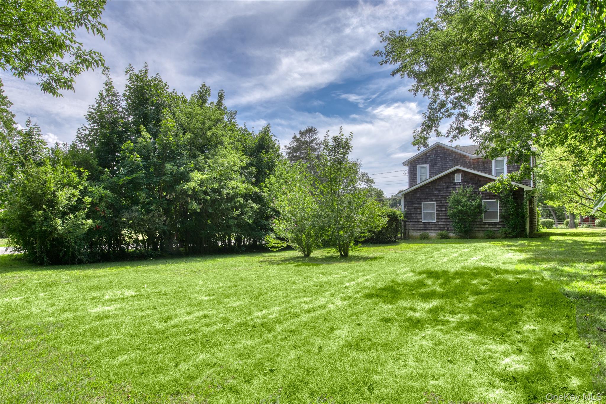385 Cottage Place Southold, NY 11971 - Photo 7 of 14 a house with a tree in front of it