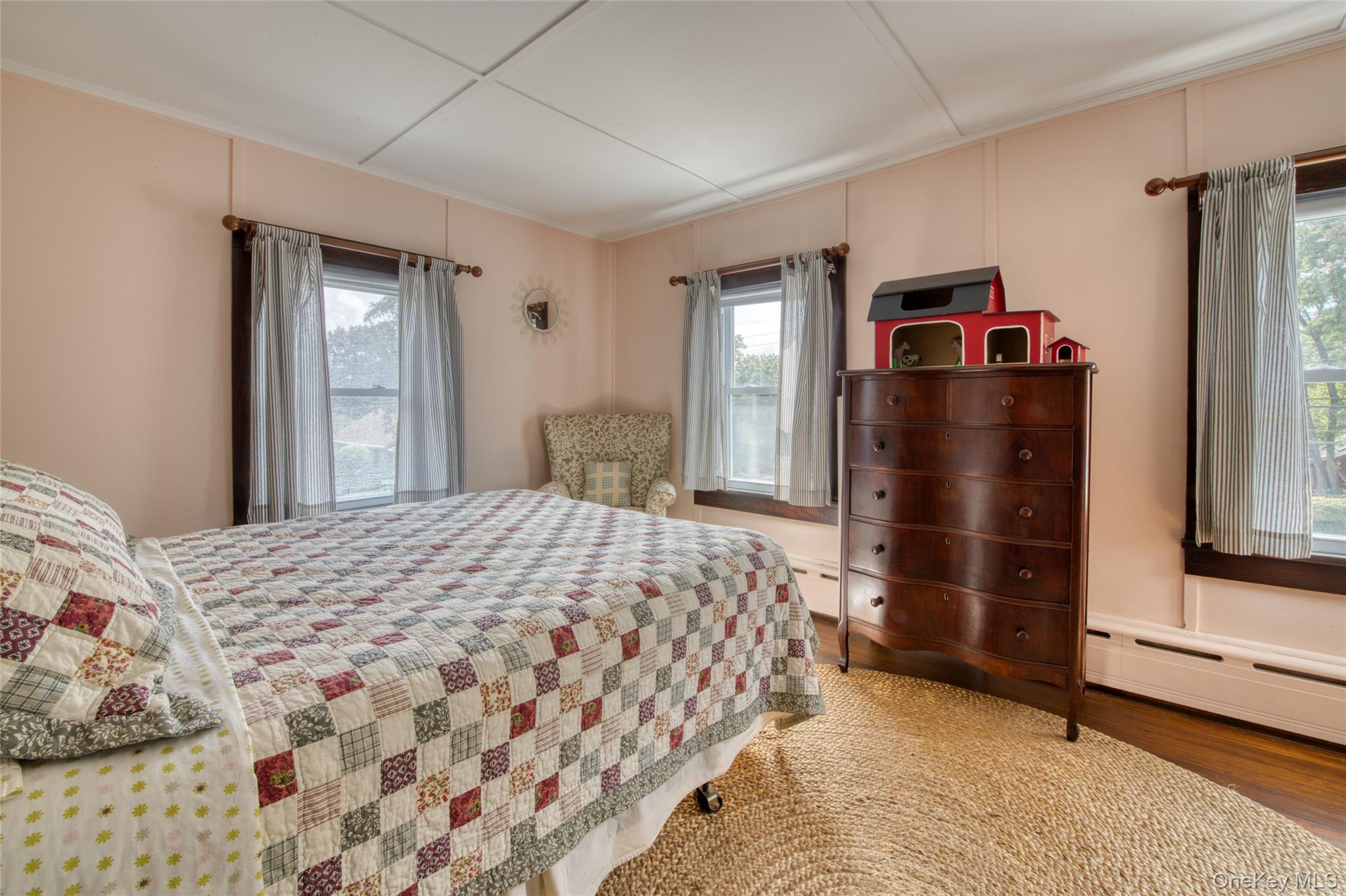 385 Cottage Place Southold, NY 11971 - Photo 10 of 14 a bedroom with a bed and a dresser