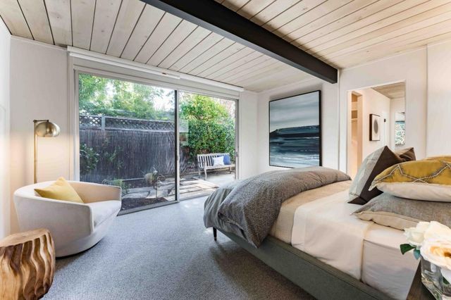 a bedroom with a bed and a large window