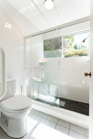 a bathroom with a toilet and a shower
