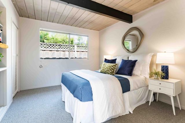 a bedroom with a bed and window