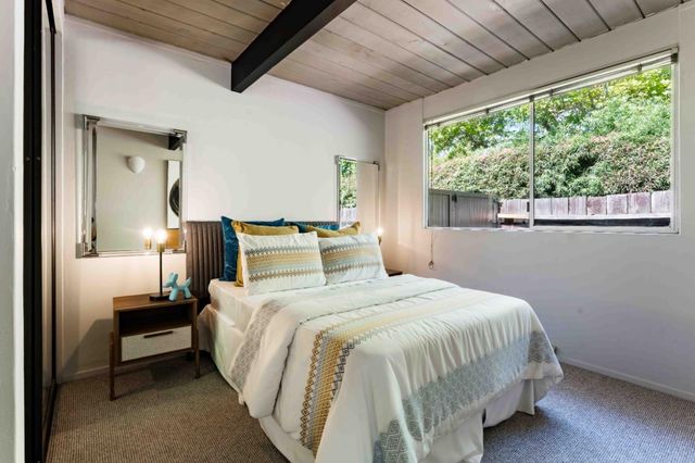 a bedroom with a bed lamp and window