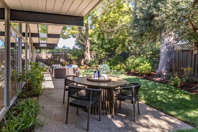 a view of a patio with couches chairs and a yard