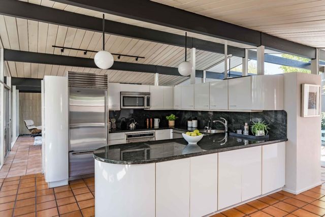 a kitchen with stainless steel appliances granite countertop a sink and cabinets