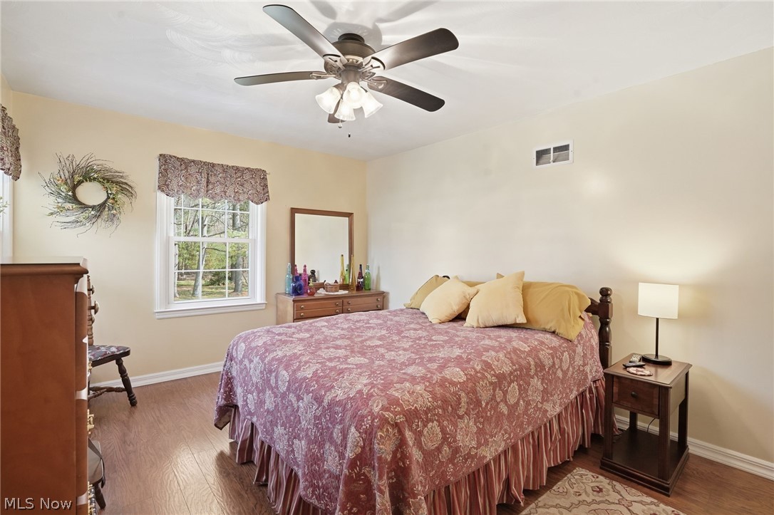 6655 Ceramic Road Crooksville, OH 43731 - Photo 15 of 34 Bedroom featuring dark wood-style floors and ceiling fan