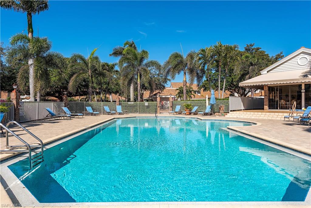 6624 Trident Way, Unit G5 Naples, FL 34108 - Photo 15 of 18 a swimming pool with outdoor seating and yard