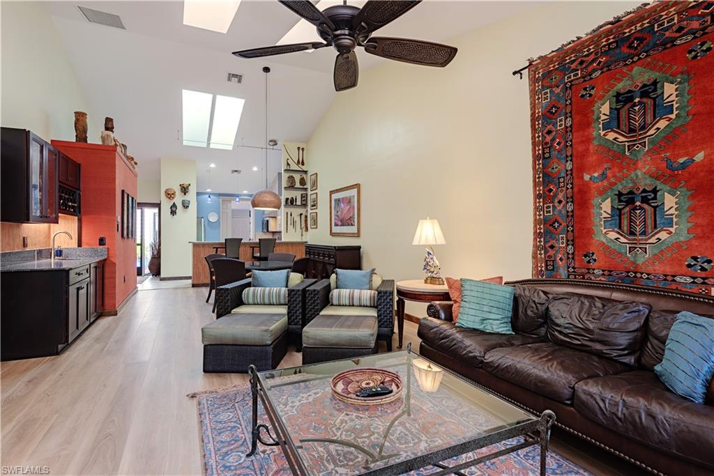 6624 Trident Way, Unit G5 Naples, FL 34108 - Photo 5 of 18 a living room with furniture and a fireplace