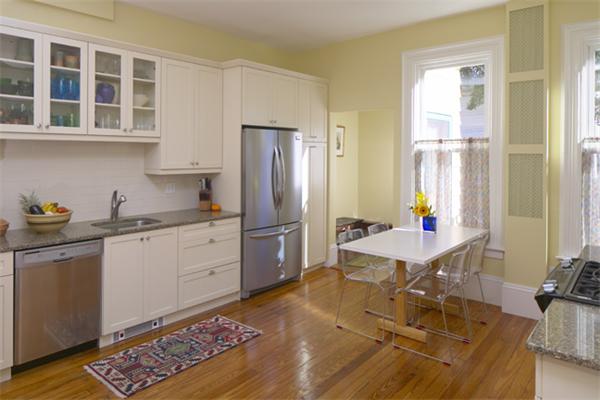 a open kitchen with stainless steel appliances granite countertop a sink dishwasher and a refrigerator with wooden floor