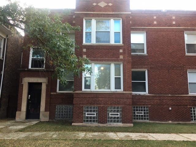 549 East 68th Street, Unit 1 Chicago, IL 60637 - Photo 1 of 8 a front view of a house with a yard