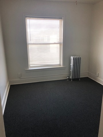 549 East 68th Street, Unit 1 Chicago, IL 60637 - Photo 6 of 8 an empty room with a window