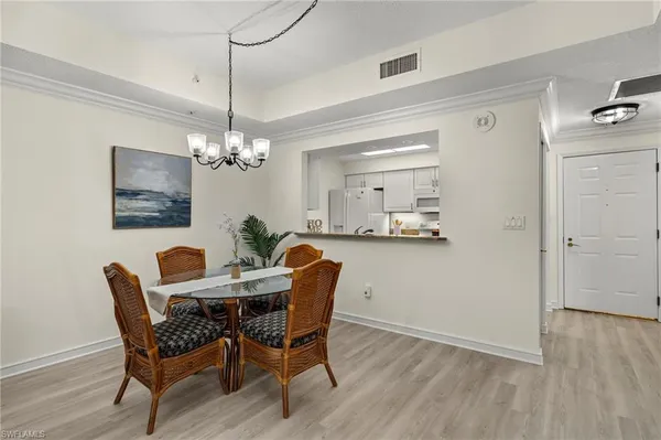 a view of a dining room with furniture wooden floor and chandelier