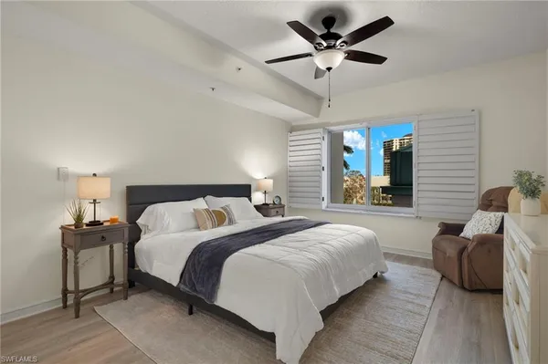 a bedroom with bed and a chandelier