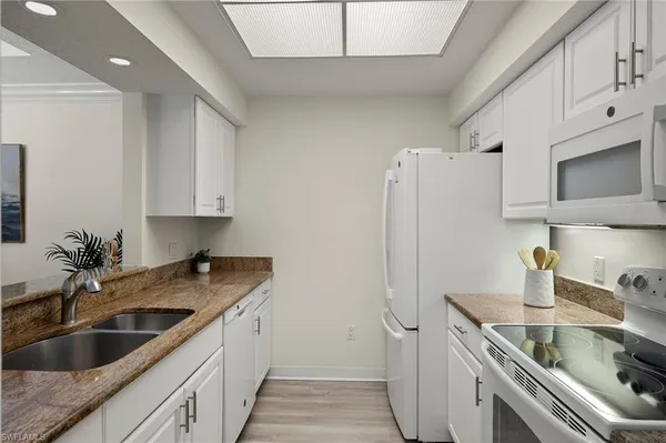 a kitchen with a sink and refrigerator