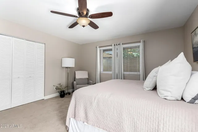 a bedroom with a large bed and a window