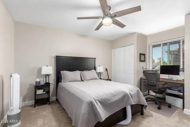 a bedroom with a bed and a desk