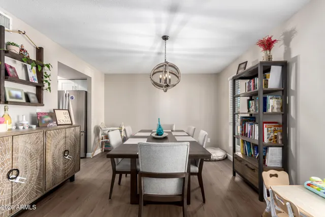 a dining room with furniture and wooden floor
