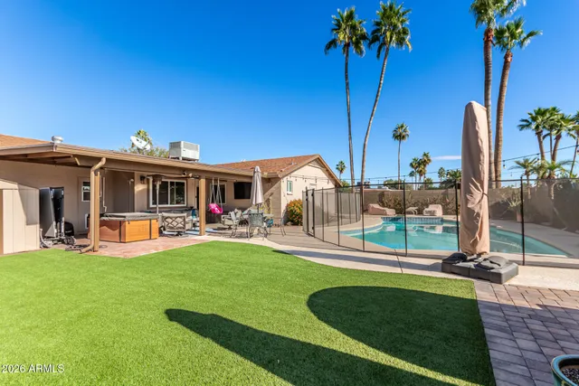 a view of a house with backyard porch and sitting area