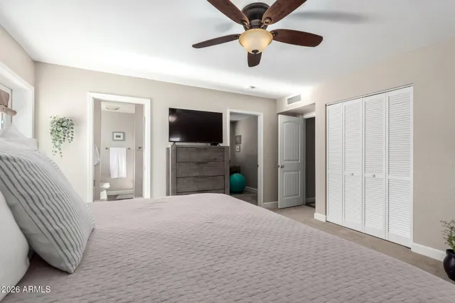 a bedroom with a bed and a flat screen tv