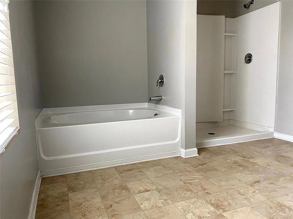 3110 Boxwood Crossing Gainesville, GA 30507 - Photo 9 of 15 a bathroom with a bathtub and a shower