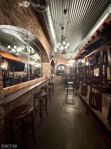 a kitchen with a sink a stove and chairs