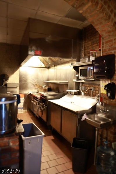 237 Haledon Avenue Haledon, NJ 07508 - Photo 20 of 49 a kitchen with a sink a stove and chairs