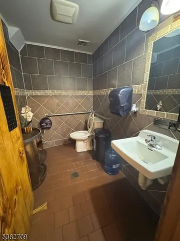 a bathroom with a granite countertop sink a toilet and bathtub