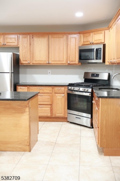 237 Haledon Avenue Haledon, NJ 07508 - Photo 26 of 49 a kitchen with stainless steel appliances granite countertop a stove a sink and a microwave