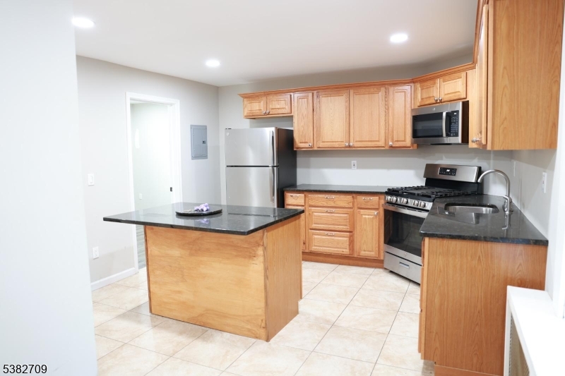 237 Haledon Avenue Haledon, NJ 07508 - Photo 28 of 49 a kitchen with stainless steel appliances granite countertop a stove a sink and a refrigerator