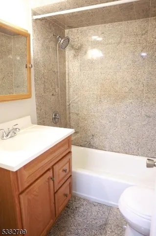 a kitchen with stainless steel appliances granite countertop a refrigerator a stove a sink and a window