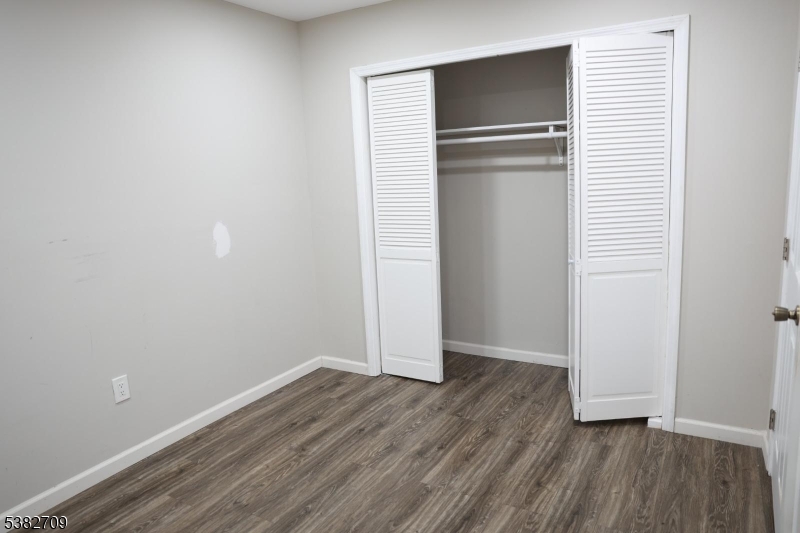 237 Haledon Avenue Haledon, NJ 07508 - Photo 30 of 49 an empty room with wooden floor and closet